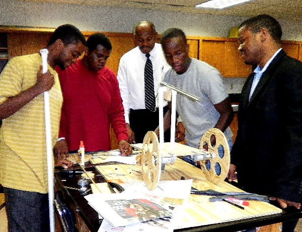 Members of the Macon County Robotics Team work together to assemble a robot.